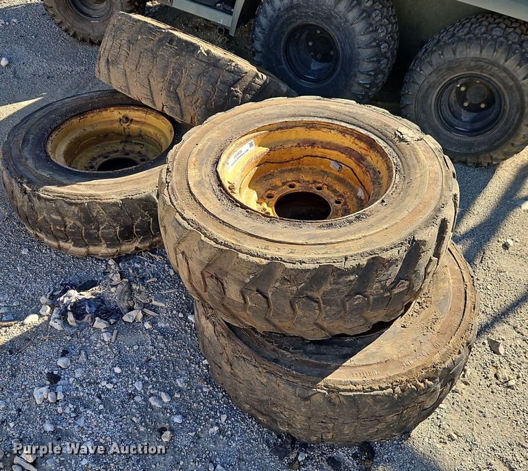 (4) 10x16.5 skid steer wheels and tires - EO4939