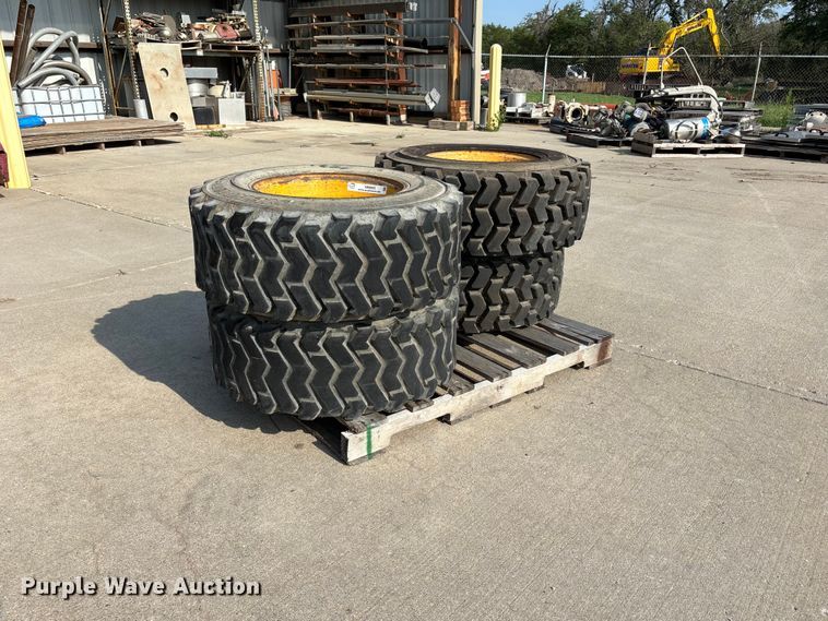 (4) 12-16.5 tires and wheels - NM9922